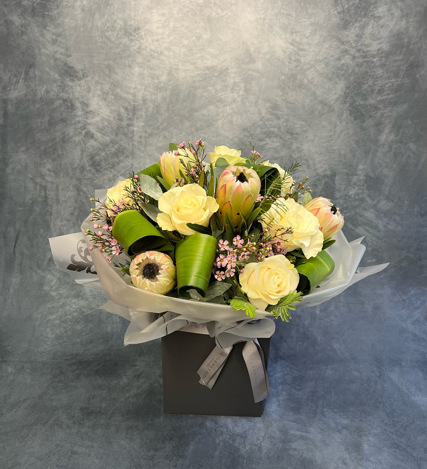 Protea and Rose Aqua flower arrangement delivered next day UK The